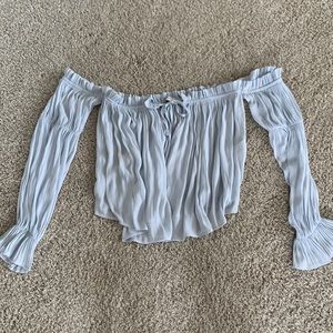 Off the shoulder long sleeve. Light blue color.